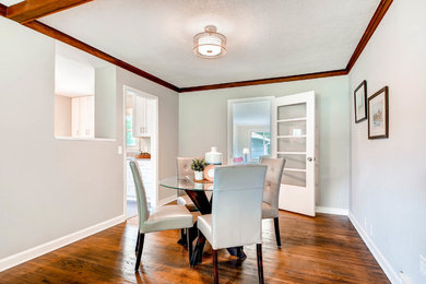 Photo of a medium sized traditional open plan dining room in Minneapolis with grey walls, medium hardwood flooring, no fireplace and brown floors.