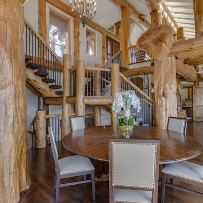 Inspiration for a mid-sized rustic dark wood floor and brown floor great room remodel in Other with white walls and no fireplace
