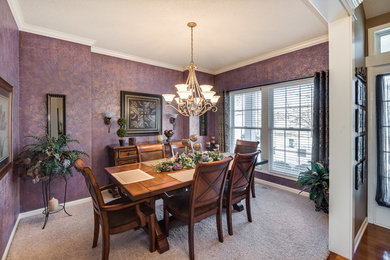Photo of a large classic dining room in Kansas City with purple walls and carpet.