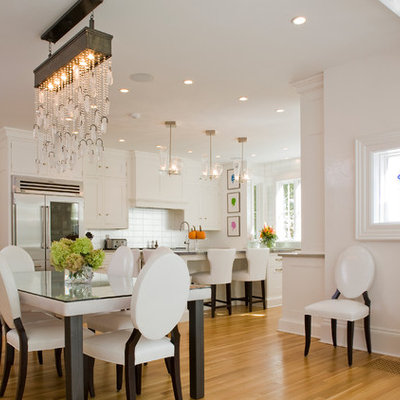 Example of a large classic medium tone wood floor great room design in New York with white walls and no fireplace