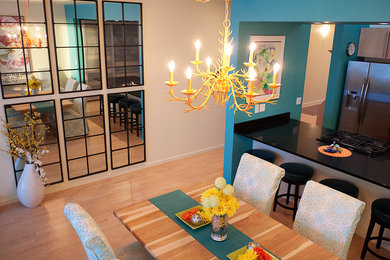 Example of a small trendy light wood floor dining room design in Other with multicolored walls
