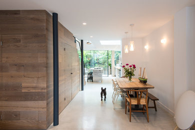 Inspiration for a large contemporary kitchen/dining room in London with concrete flooring and white floors.
