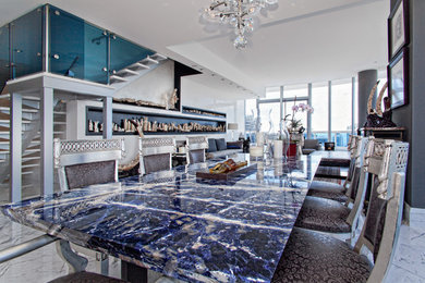 Mid-sized trendy marble floor great room photo in Miami with white walls and no fireplace