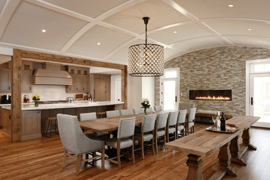 Example of a large transitional medium tone wood floor and brown floor great room design in DC Metro with white walls, a ribbon fireplace and a stone fireplace