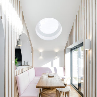 Design ideas for a medium sized contemporary open plan dining room in London with medium hardwood flooring, brown floors and multi-coloured walls.