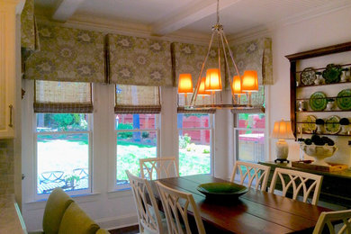Example of a mid-sized classic dark wood floor and brown floor enclosed dining room design in Raleigh with white walls and no fireplace