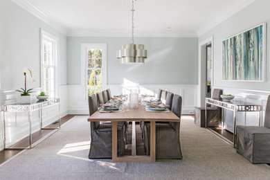 Mid-sized trendy dark wood floor enclosed dining room photo in Other with blue walls