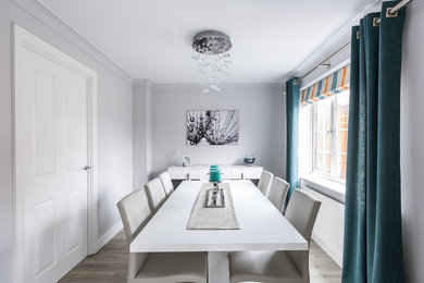 This is an example of a medium sized modern dining room in Sussex.