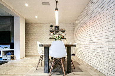 Inspiration for a large modern kitchen/dining room in London with white walls, concrete flooring and grey floors.