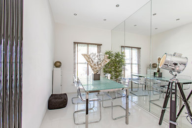 Inspiration for a medium sized modern dining room in London with white walls, no fireplace and white floors.