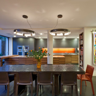 Design ideas for a contemporary kitchen/dining room in London with beige walls and grey floors.