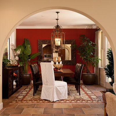 Example of a mid-sized tuscan slate floor enclosed dining room design in San Diego with beige walls and no fireplace