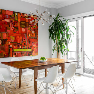 Immagine di una sala da pranzo aperta verso il soggiorno minimal di medie dimensioni con pareti grigie, parquet chiaro e pavimento beige