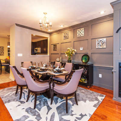 Inspiration for a timeless medium tone wood floor dining room remodel in DC Metro with gray walls and a standard fireplace