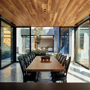 This is an example of a large contemporary kitchen/dining combo in Melbourne with limestone floors and grey floor.
