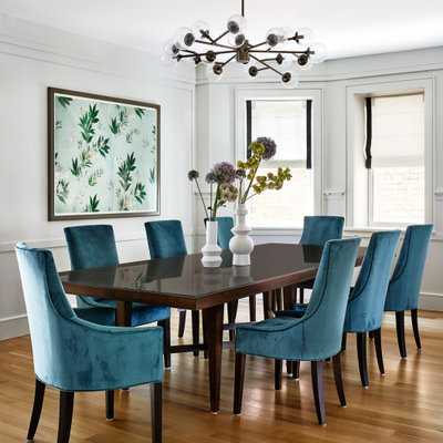 Large transitional medium tone wood floor and brown floor dining room photo in Los Angeles with gray walls