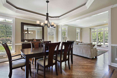 Great room - mid-sized traditional medium tone wood floor great room idea in Atlanta with beige walls and no fireplace