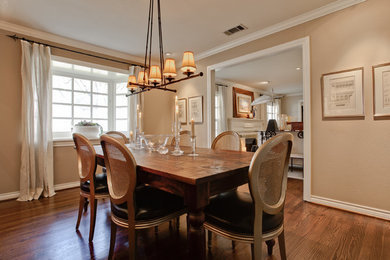 Example of a mid-sized transitional medium tone wood floor enclosed dining room design in Dallas with beige walls and no fireplace