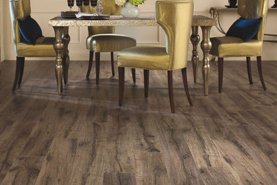 Example of a classic laminate floor and brown floor dining room design