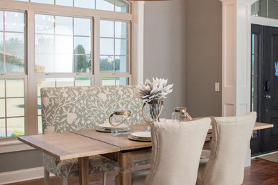 Example of a trendy medium tone wood floor dining room design in Cleveland with gray walls