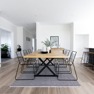 Photo of a scandinavian dining room in Perth with white walls, medium hardwood floors and brown floor.
