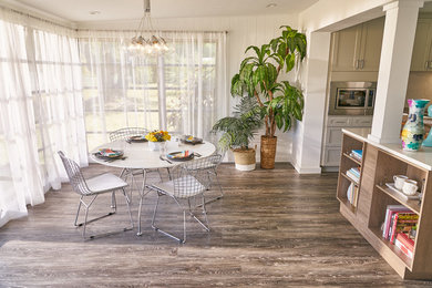 Mid-sized transitional brown floor kitchen/dining room combo photo in Tampa with white walls