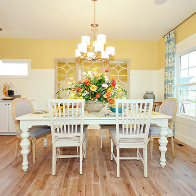 Kitchen/dining room combo - traditional medium tone wood floor kitchen/dining room combo idea in Denver with yellow walls