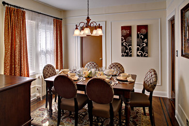 Enclosed dining room - small traditional medium tone wood floor and brown floor enclosed dining room idea in New York with beige walls and no fireplace