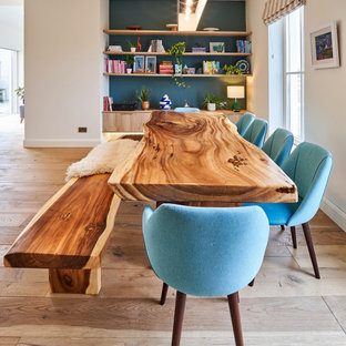 Large classic open plan dining room in Other with medium hardwood flooring, white walls and beige floors.