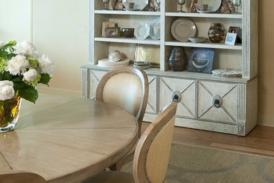 Photo of a small traditional open plan dining room in Houston with beige walls, medium hardwood flooring and no fireplace.