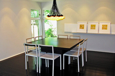 Photo of a modern dining room in Chicago with dark hardwood flooring.