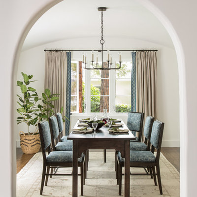 Inspiration for a mediterranean dark wood floor and brown floor enclosed dining room remodel in San Francisco with white walls