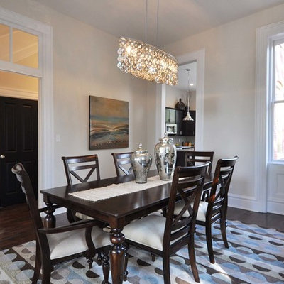 Example of a mid-sized classic dark wood floor enclosed dining room design in St Louis with beige walls