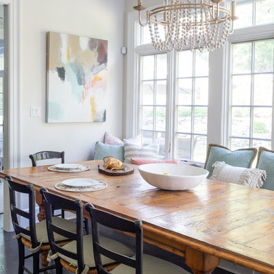 Example of a small beach style dark wood floor dining room design in New York with beige walls and no fireplace