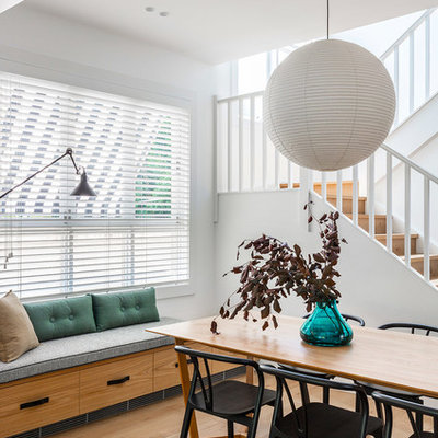 Dining room - contemporary medium tone wood floor and brown floor dining room idea in Melbourne with white walls