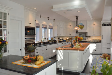 Example of a classic eat-in kitchen design in Portland Maine with shaker cabinets, granite countertops and white cabinets