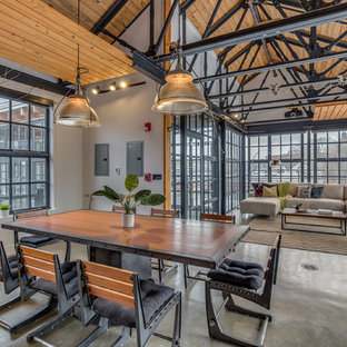 Urban concrete floor great room photo in Boston with white walls