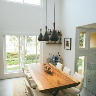 Example of a small trendy dining room design in Orange County with white walls and no fireplace