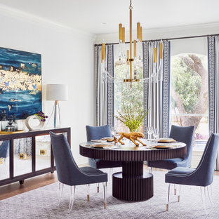 Example of a mid-sized transitional medium tone wood floor and brown floor dining room design in Austin with white walls