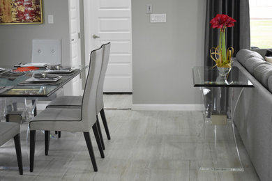 Foto de comedor clásico renovado de tamaño medio cerrado con paredes grises, suelo de madera clara y suelo gris