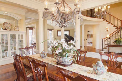 Enclosed dining room - large traditional dark wood floor and brown floor enclosed dining room idea in Raleigh with beige walls and no fireplace