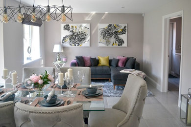 Design ideas for a large contemporary open plan dining room in Buckinghamshire with grey walls, porcelain flooring, no fireplace, grey floors and feature lighting.