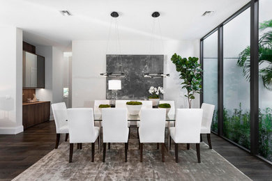 Inspiration for a huge contemporary brown floor great room remodel in Miami with white walls