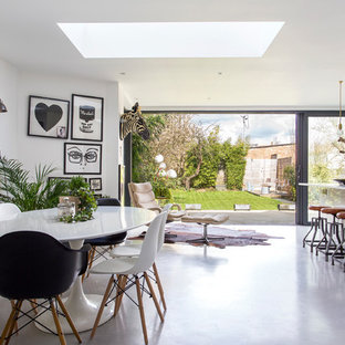 Design ideas for a medium sized contemporary kitchen/dining room in London with white walls, concrete flooring and grey floors.