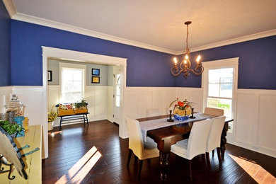 This is an example of a medium sized traditional open plan dining room in Louisville with blue walls, dark hardwood flooring, no fireplace and brown floors.