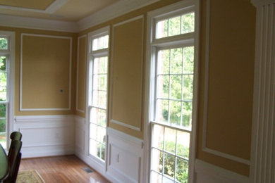 Medium tone wood floor dining room photo in Charlotte with yellow walls