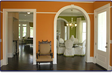 Dining room - dark wood floor dining room idea in New York with orange walls