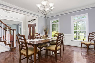 Dining room - mid-sized dark wood floor and brown floor dining room idea in Baltimore with gray walls