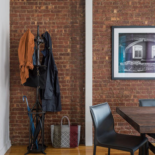 Dining room - mid-sized industrial medium tone wood floor dining room idea in New York with white walls, a standard fireplace and a stone fireplace