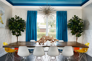 Example of a trendy dining room design in Miami with metallic walls and no fireplace